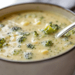 Single serving of creamy low carb broccoli cheese soup in a ceramic bowl