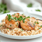 Plated one pot chicken and rice with parsley garnish