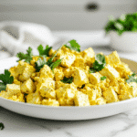 Easy tofu breakfast scramble served on a white plate and fork