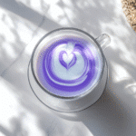 overhead ube latte with milk swirl on kitchen counter