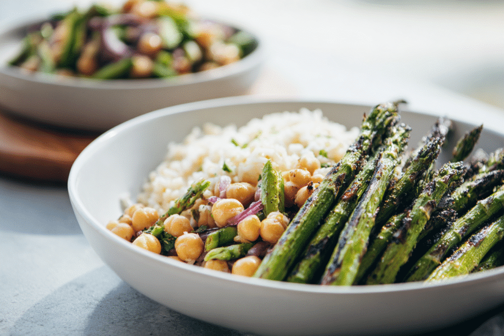 Chickpea salad and grilled asparagus with rice on modern white kitchen counter