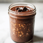 Single-serve overnight oats with dark chocolate and sea salt in a glass jar