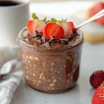 Single-serving jar of chocolate strawberry overnight oats with fresh toppings