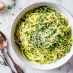 Finished zucchini spaghetti with written recipe card