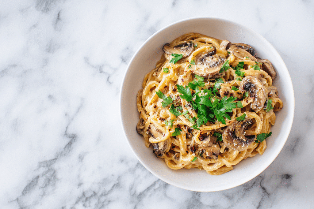 Mushroom One Pot Pasta served in a white bowl on a white kitchen countertop
