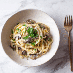 Finished serving of mushroom one pot pasta in a white bowl