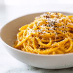 Plated Pumpkin Parmesan Spaghetti with parmesan garnish