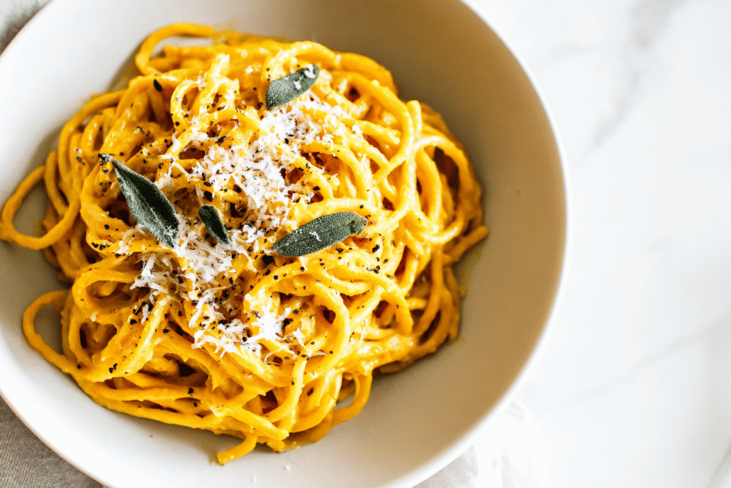 Creamy Pumpkin Parmesan Spaghetti served in a white bowl on modern countertop