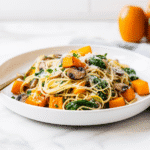 recipe card layout with cooked autumn veggie spaghetti